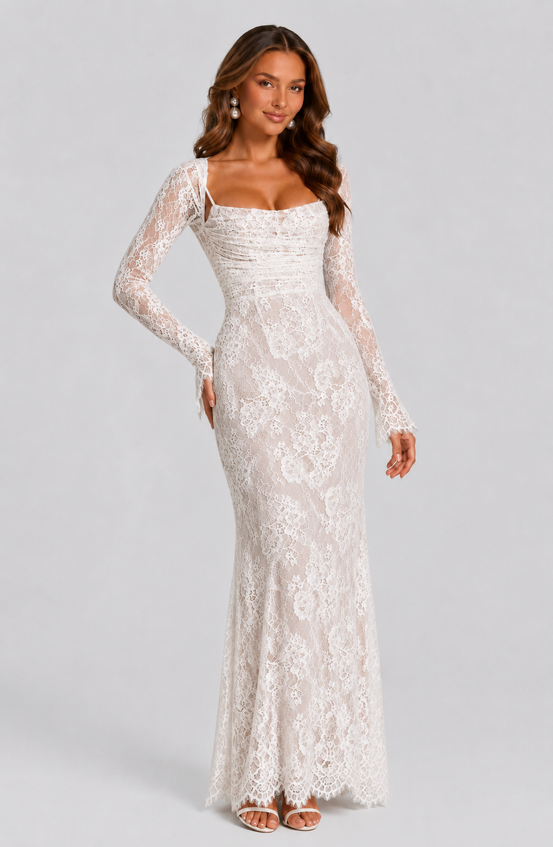 Woman wearing a white lace dress on a gray background