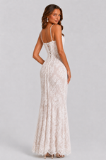 Woman wearing a white lace dress on a gray background