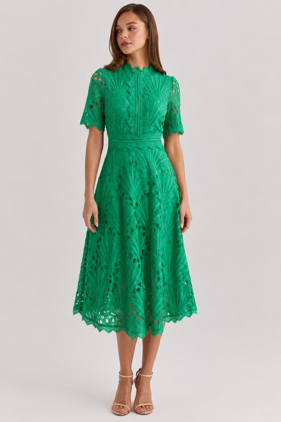 Green lace dress worn by a model on a light gray background