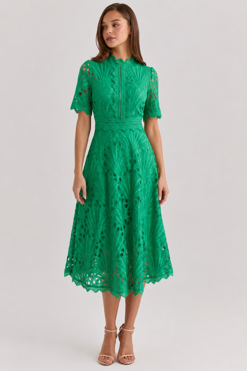 Green lace dress worn by a model on a light gray background