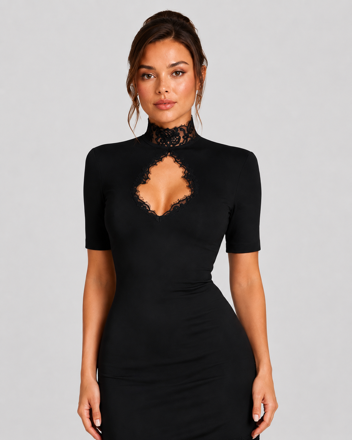 Woman wearing a black dress with lace detailing on a gray background
