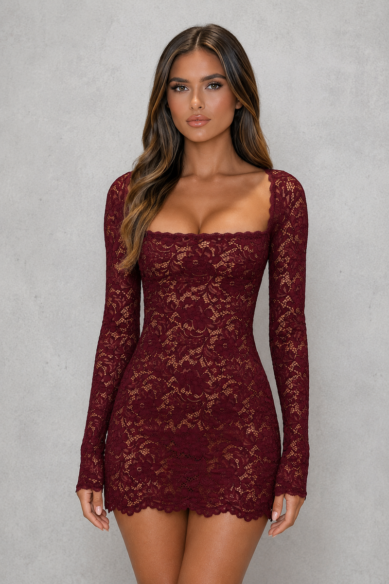 Woman wearing a burgundy lace dress against a gray background