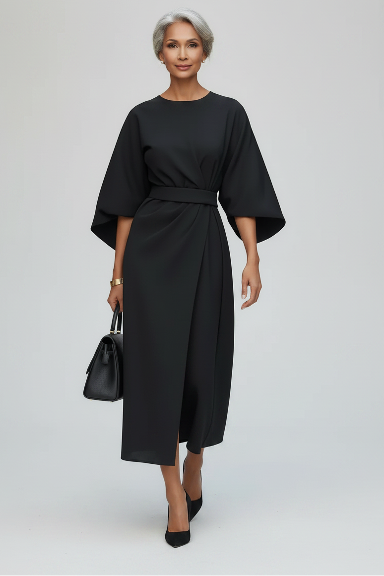 Woman wearing a black dress on a city street