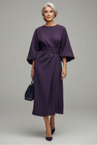 Person wearing a purple dress on a city street