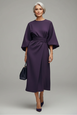 Person wearing a purple dress on a city street