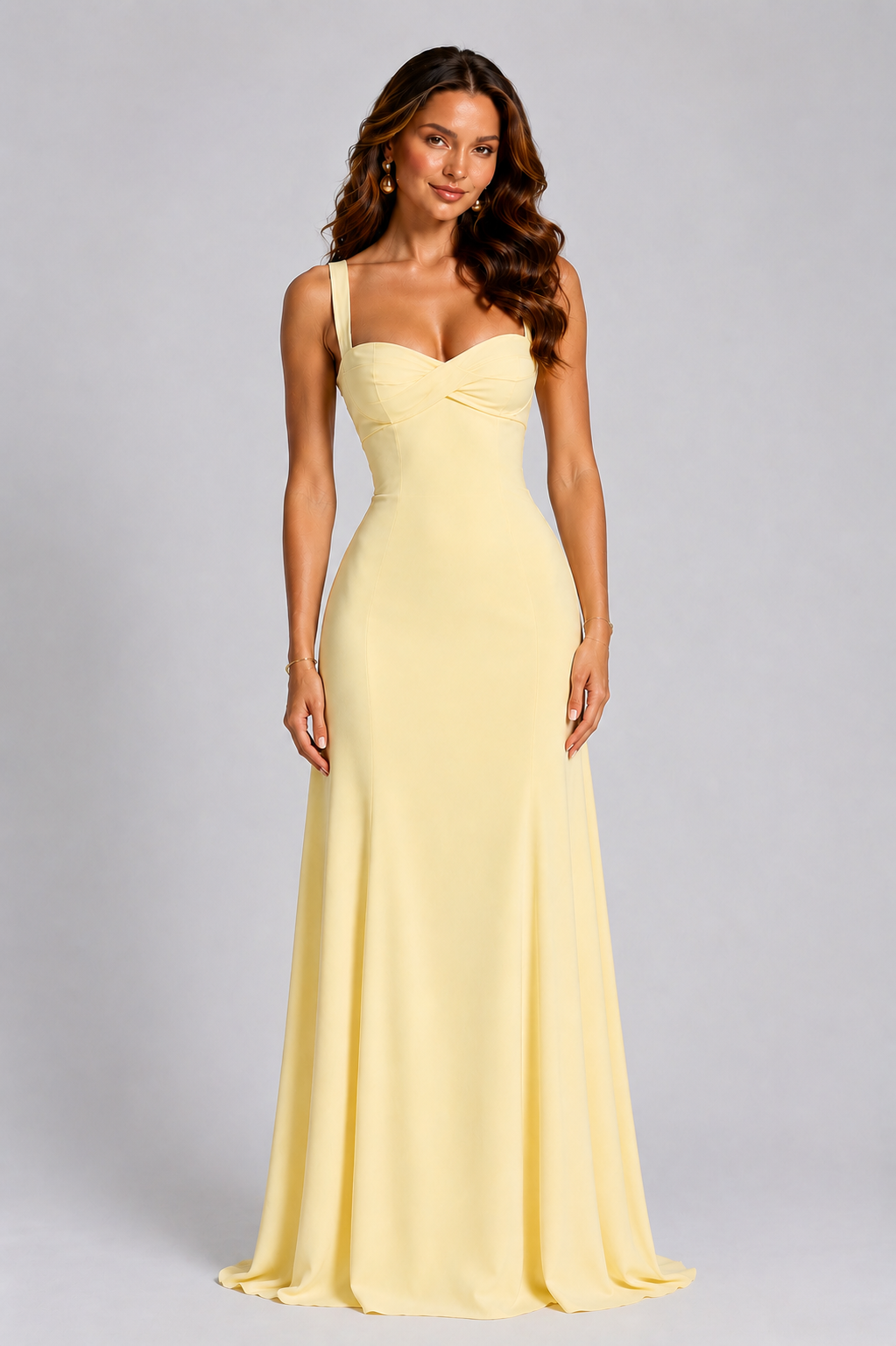 Woman wearing a yellow evening gown against a gray background