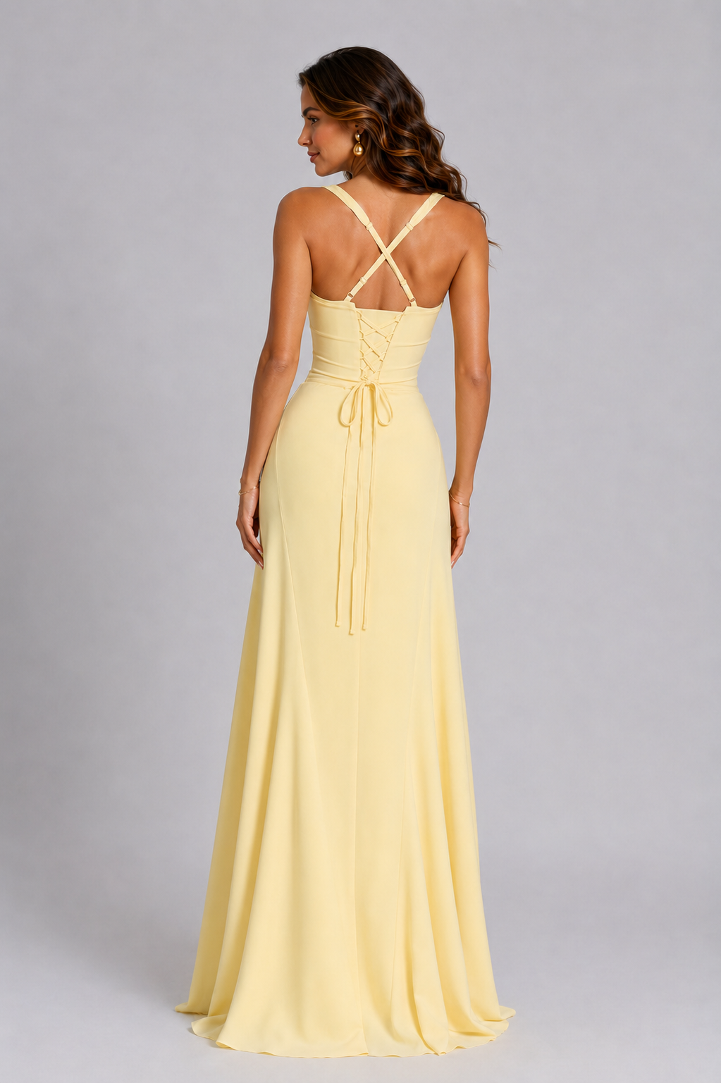 Woman wearing a yellow evening gown with a gray background