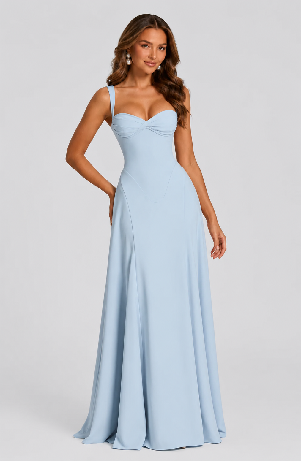 Woman wearing a light blue evening gown against a gray background