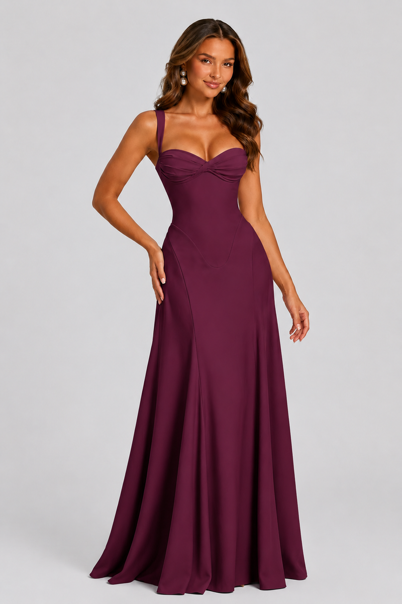 Woman wearing a burgundy evening gown on a gray background