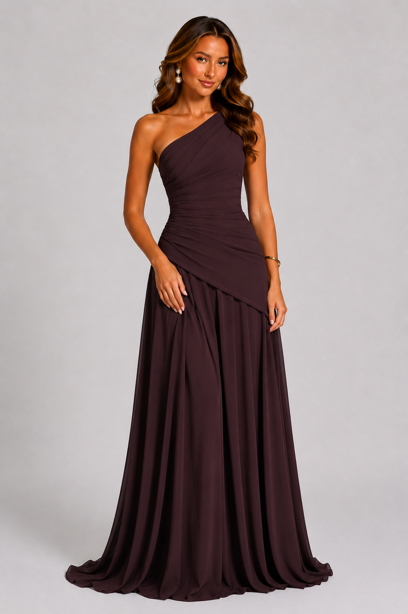 Woman wearing a one-shoulder brown evening gown on a gray background