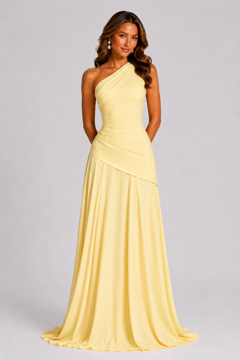 Woman wearing a yellow one-shoulder gown on a gray background