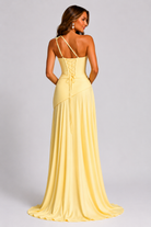 Woman wearing a yellow evening gown with a plain background