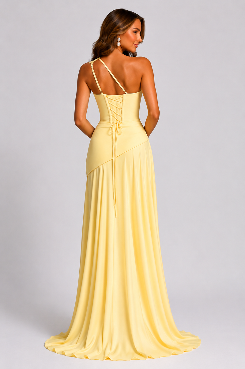 Woman wearing a yellow evening gown with a plain background