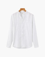 White shirt on a wooden hanger against a white background