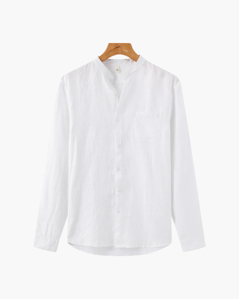 White shirt on a wooden hanger against a white background