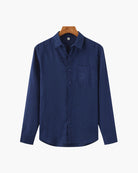 Blue shirt on a hanger against a white background