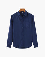 Blue shirt on a hanger against a white background