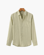 Beige button-up shirt on a hanger against a white background