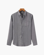 Gray button-up shirt on a hanger against a white background