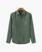 Green shirt on a hanger with a white background