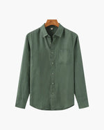 Green shirt on a hanger with a white background
