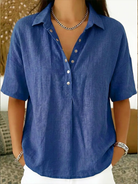 Person wearing a blue shirt with a neutral background