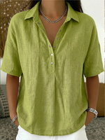 Green shirt worn by a person with a blurred background
