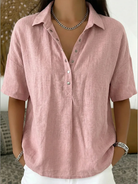 Pink linen shirt worn by a person with a blurred background