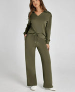 Woman wearing an olive green tracksuit on a white background