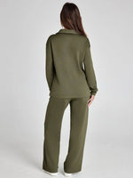 Woman wearing an olive green outfit on a white background