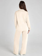 Woman wearing a beige suit on a gray background