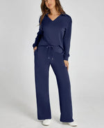 Woman wearing a navy blue tracksuit on a white background