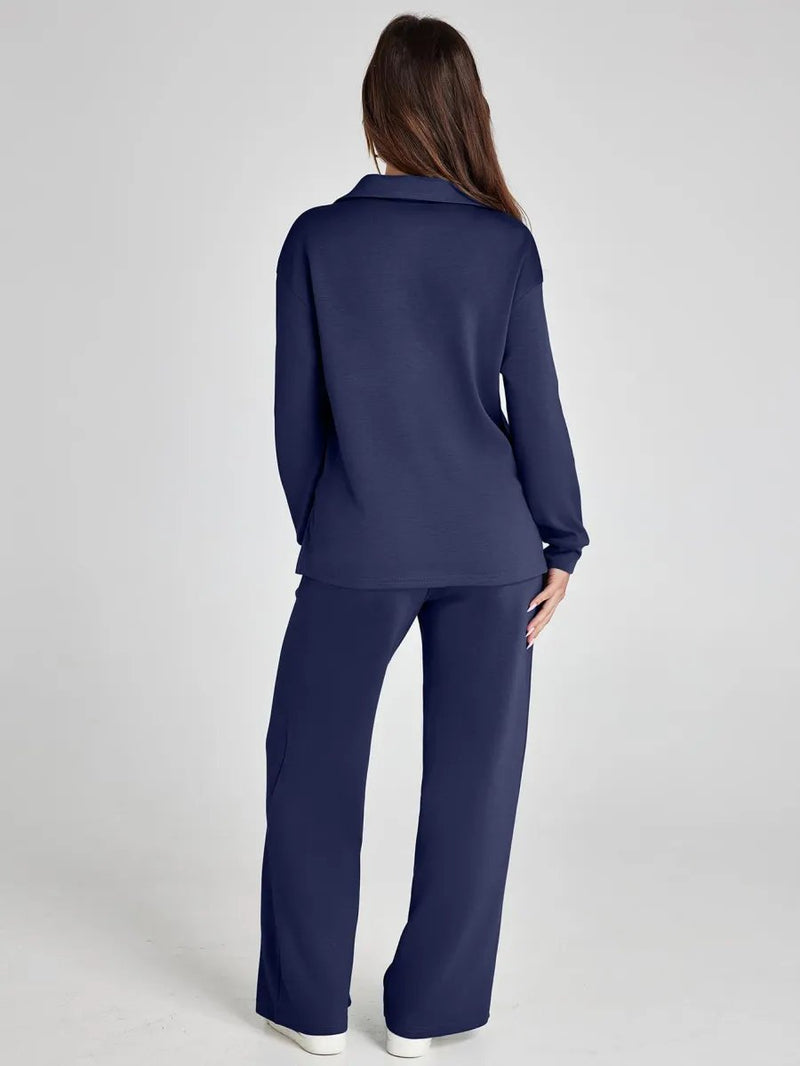 Person wearing a navy blue outfit on a light gray background