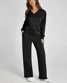 Woman wearing a black outfit with a white background
