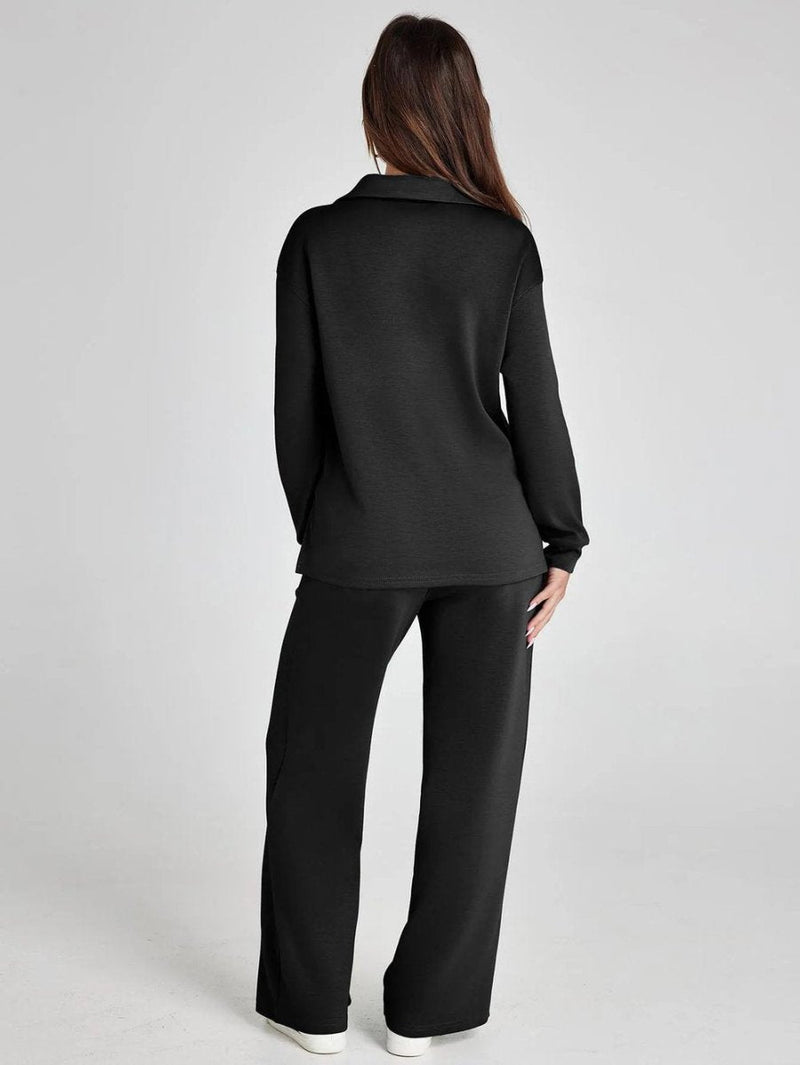 Person wearing a black outfit on a plain background