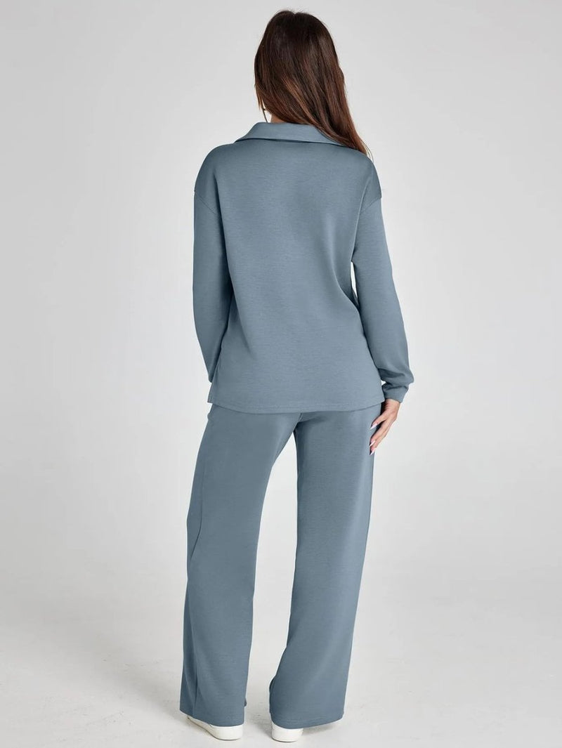 Woman wearing a gray outfit on a plain background