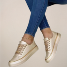 Women’s low top sneakers with gold accents and cushioned sole
