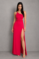 Woman wearing a red one-shoulder dress with a high slit on a gray background
