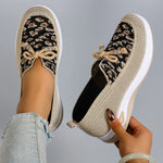 Pair of patterned shoes with a neutral background