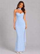 Woman wearing a light blue strapless gown on a gray background