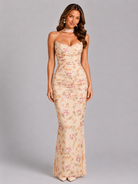Woman wearing a floral strapless gown on a gray background