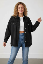 Woman wearing a black denim jacket and blue jeans on a white background