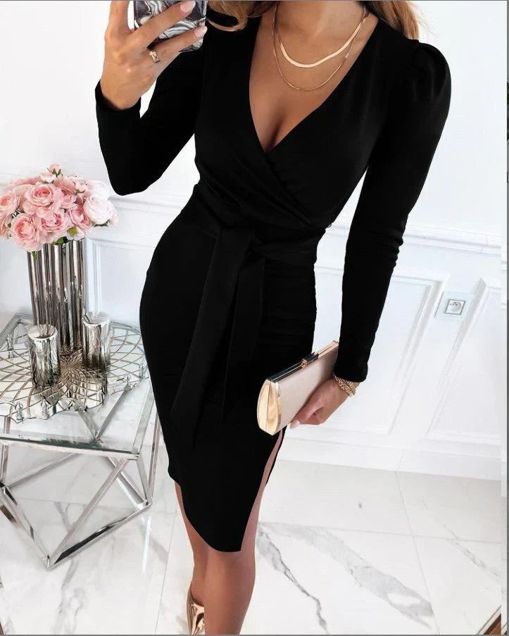 Person wearing a black dress in an elegant room with flowers and candles.