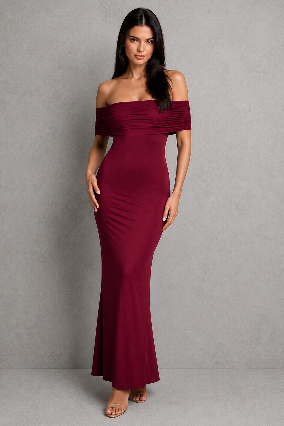 Woman wearing a burgundy off-shoulder gown against a gray background