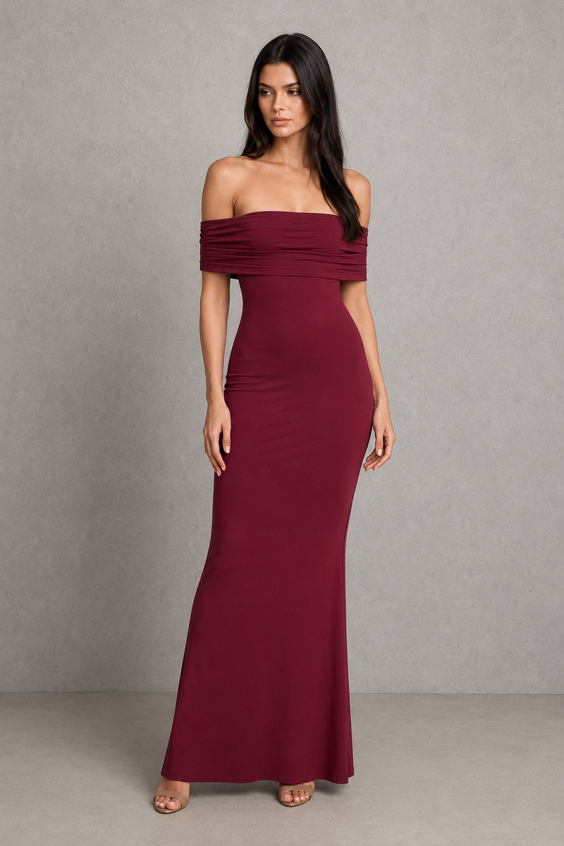 Woman wearing a burgundy off-shoulder gown against a gray background