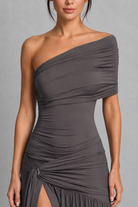 Gray one-shoulder dress on a model against a gray background