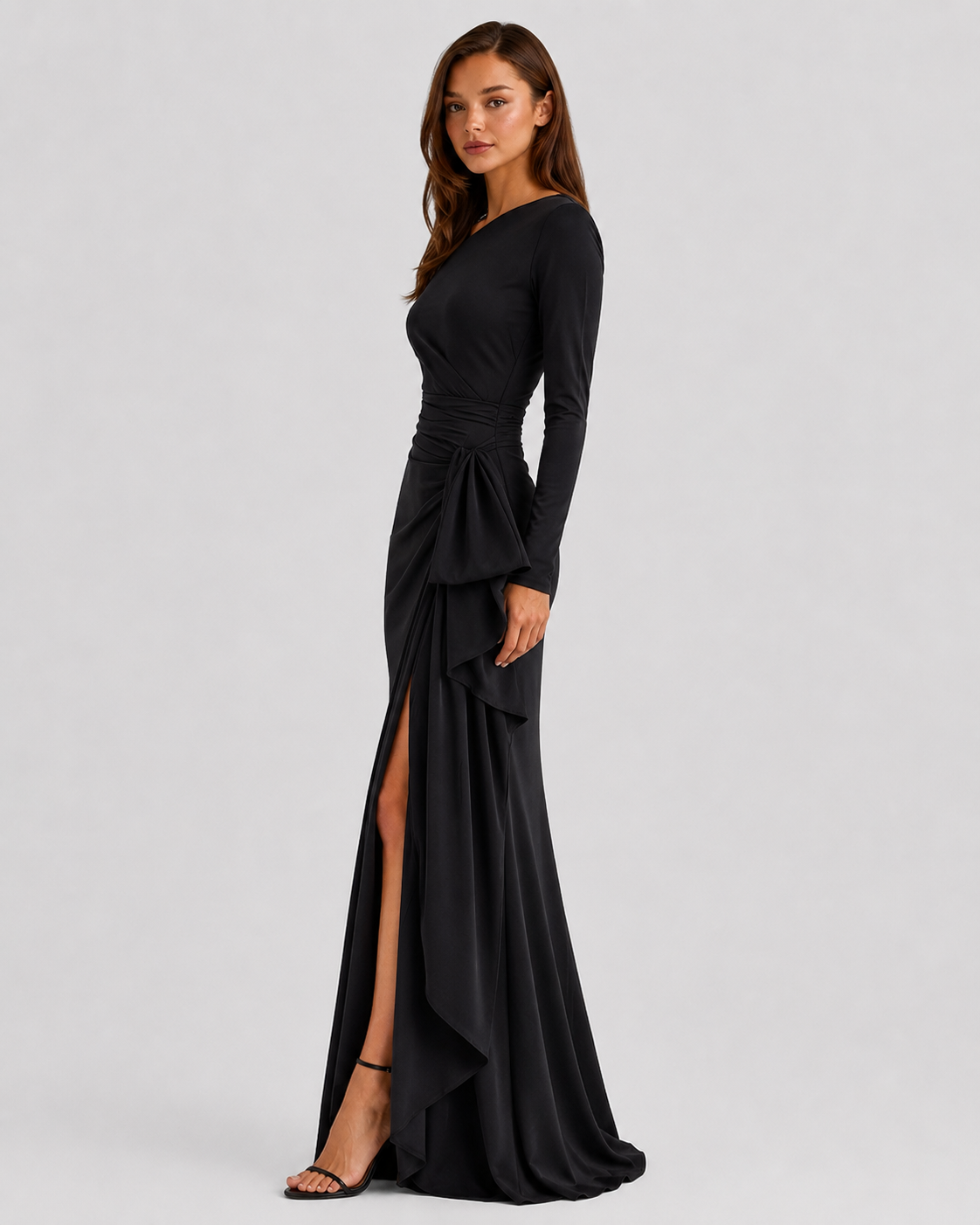 Black evening gown with long sleeves and a slit on a white background