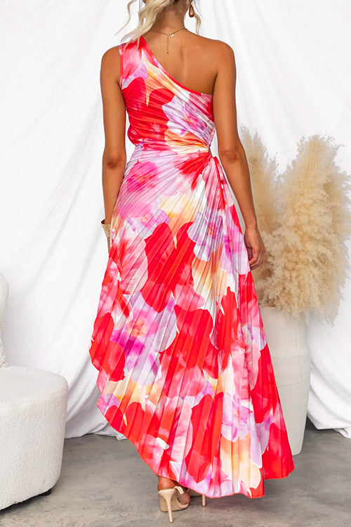 Woman wearing a colorful one-shoulder dress with a white background