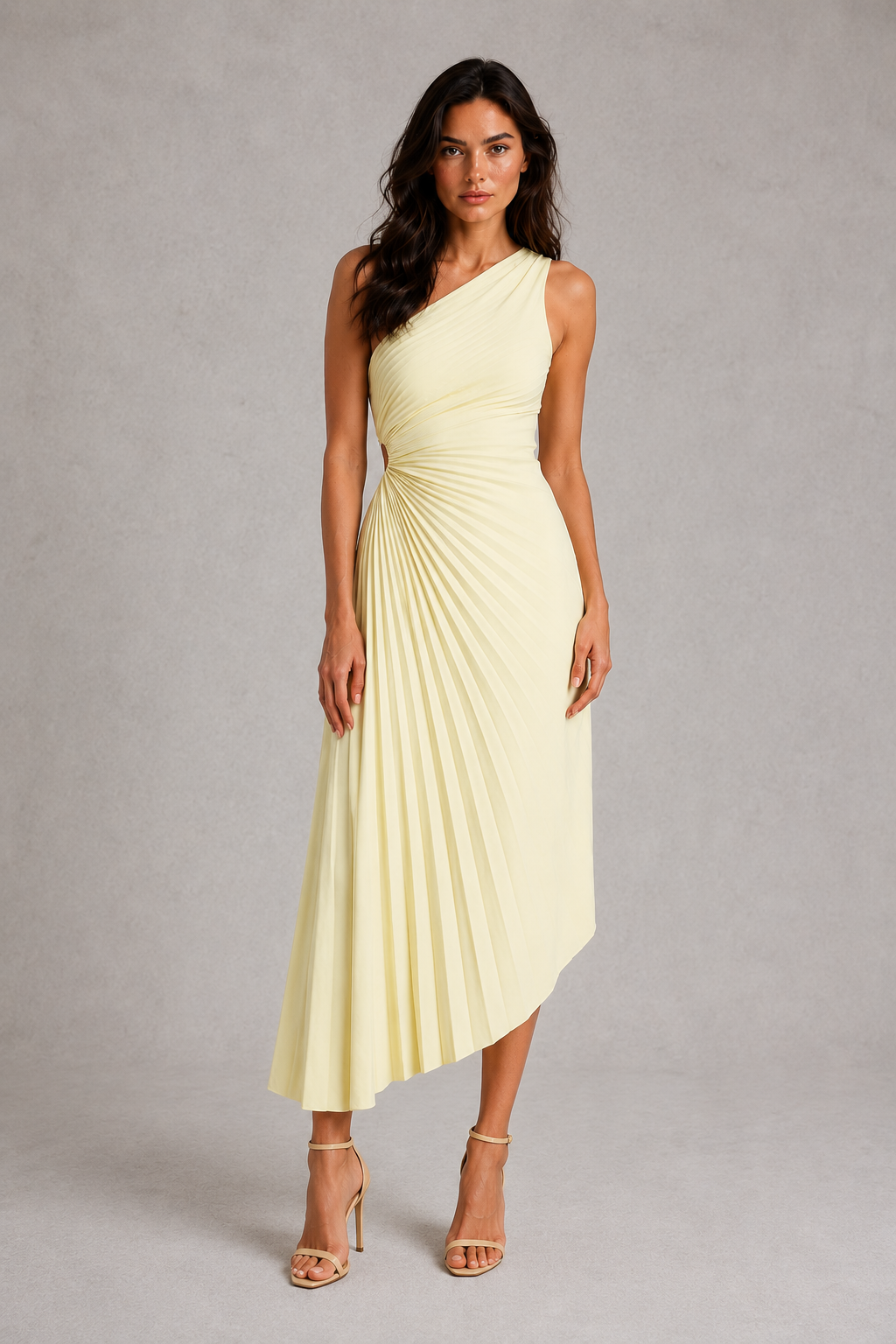 Woman wearing a light yellow one-shoulder dress on a gray background