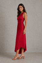 Woman wearing a red dress against a neutral background
